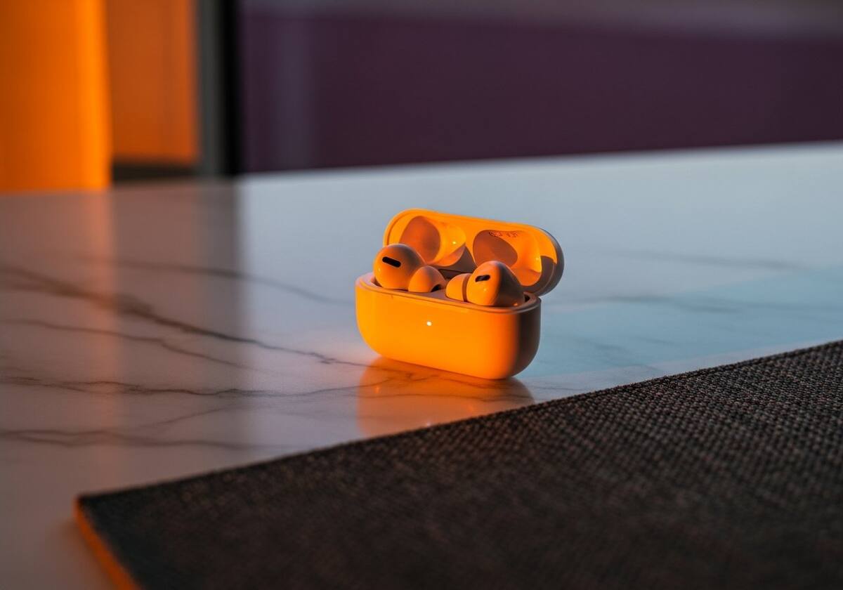 Wireless earbuds beside a smartphone